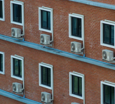 Air Conditioning Units on a Brick Wall of an Apartment Complex