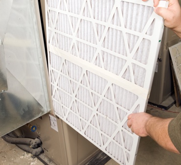 Changing a residential air filer on a heating and air conditioning unit